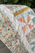 Handmade sage green quilt with pinwheel pattern, lightened true-to-color sage green